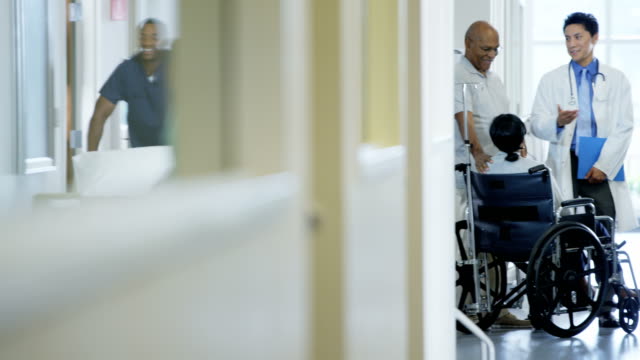 Ethnic-disabled-senior-female-in-wheelchair-in-hospital