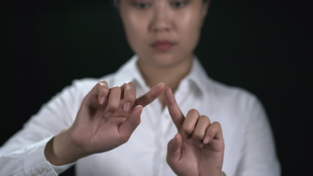 Woman-Making-Zooming-Gesture-on-Invisible-Screen