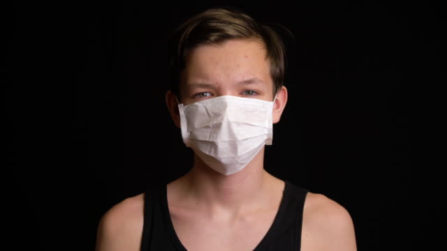 Boy-feeling-sick-and-wearing-mask.