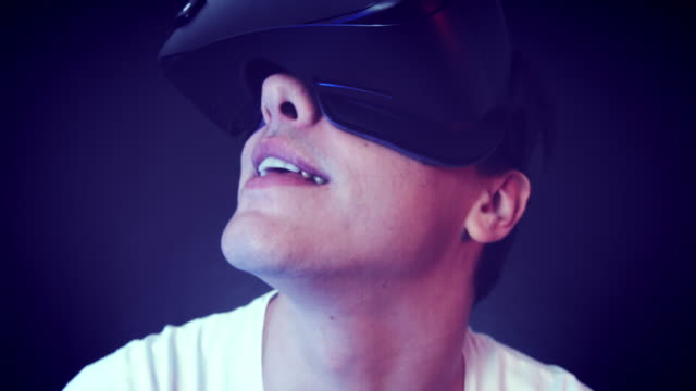 Lachender-junge-Mann-VR-Kopfhörer-tragen-und-virtuelle-Realität-erfahren