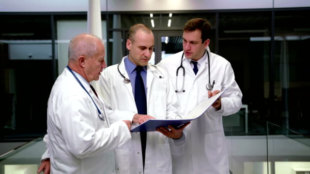 Team-of-doctors-discussing-over-medical-report