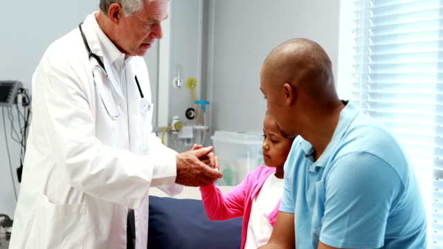 Male-doctor-examining-patient