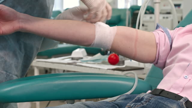 Nurse-Wrapping-Gauze-around-Arm-of-Donor