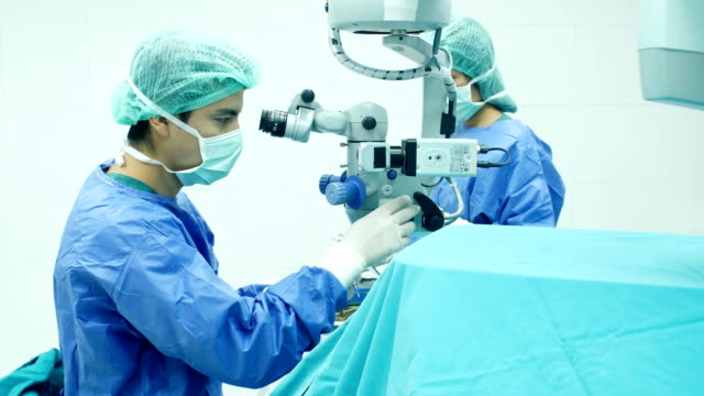 Male-and-female-surgeons-operate-the-machinery.-Medical-and-Healthcare-concept.