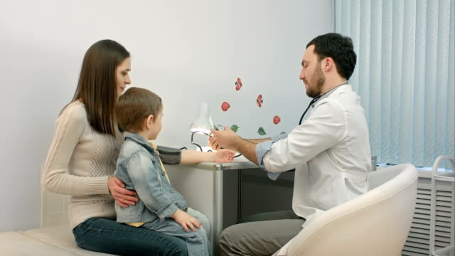 Arzt-messen-den-Blutdruck-von-einem-Kind-im-Prüfungsraum