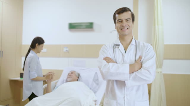 Portrait-of-handsome-caucasian-doctor-smiling-in-hospital-Ward