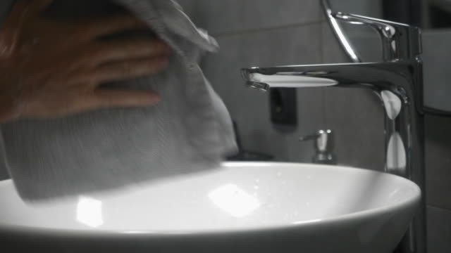 Hand-washing-to-prevent-coronavirus-Covid-19-infection.-Man-washes-hands-with-soap-in-sink-at-modern-bathroom.-Male-is-washing-and-lathering-hands-with-foam