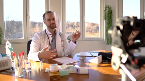 Doctor-giving-online-consultation-to-patient-by-video-call-from-his-office-about-COVID-19-prevention