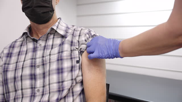 close-up-of-a--caucasian-man-being-vaccinated-in-the-shoulder