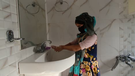 Masked-girl-Washing-hands-with-soap-and-water-and-using-alcohol-based-hand-rub-kills-viruses.