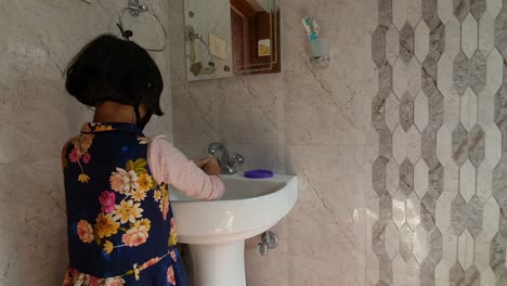 Masked-girl-Washing-hands-with-soap-and-water-and-using-alcohol-based-hand-rub-kills-viruses.