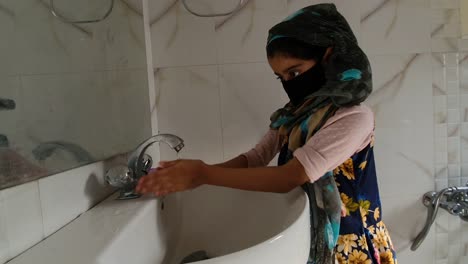 Masked-girl-Washing-hands-with-soap-and-water-and-using-alcohol-based-hand-rub-kills-viruses.