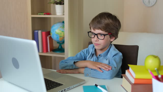 Child-Boy-Kid-schoolboy-in-glasses-using-tablet-laptop-computer-for-school-homework,-studying-at-home