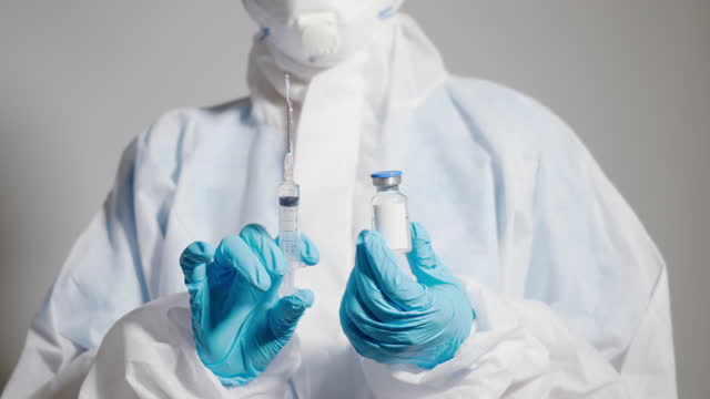 doctor-hold-medicine-liquid-vaccine-vial-bottle-and-syringe