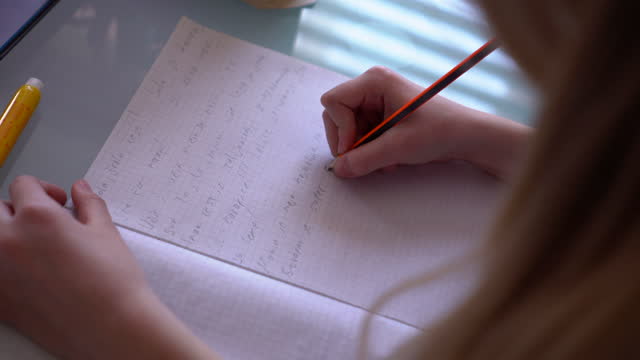 Girl-writing-homework-at-home