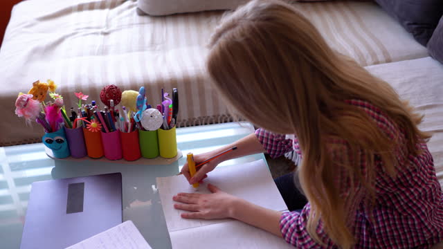 Girl-writing-her-homework-assignment-at-home