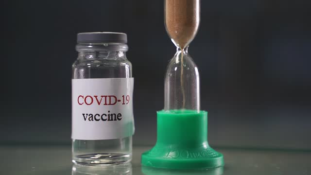 Nahaufnahme-einer-Flasche-mit-dem-COVID-19-Coronavirus-Impfstoff,-einem-Heilmittel-gegen-die-Pandemie.-Das-Konzept-der-Bekämpfung-des-Coronavirus,-Zeit-für-die-Impfung
