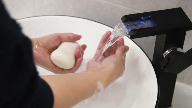 Slow-motion-video-of-woman-washing-hands-with-a-soap