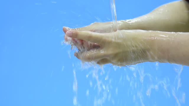 Slow-motion-video-of-washing-hand-with-foam-against-blue-background
