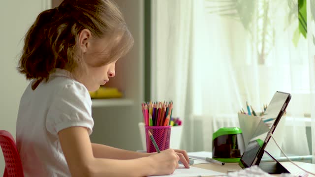Cute-child-use-laptop-for-education,-online-study,-home-studying.-Girl-have-homework-at-home-schooling.