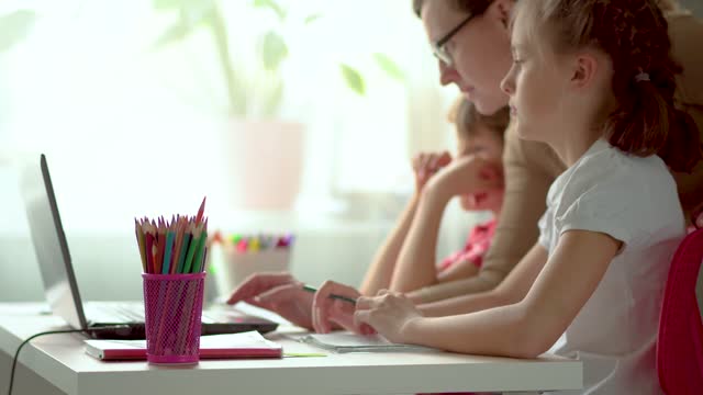 Online-Fernunterricht-für-Kinder.-Sohn-und-Tochter-nutzen-einen-Laptop-für-die-Ausbildung.