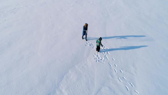 Mother-and-son-playing-snowball-in-winter.-Family-time-walk-and-play-together