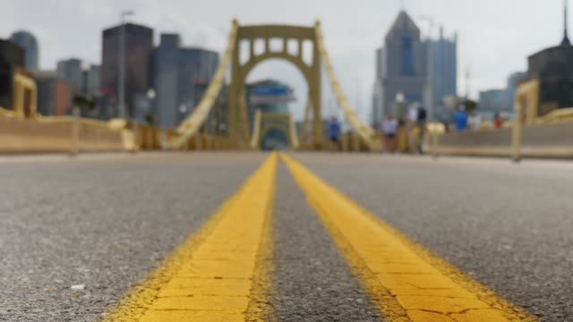 Slow-Dolly-Tracking-Shot-of-6th-Street-Bridge-and-Pittsburgh-Skyline