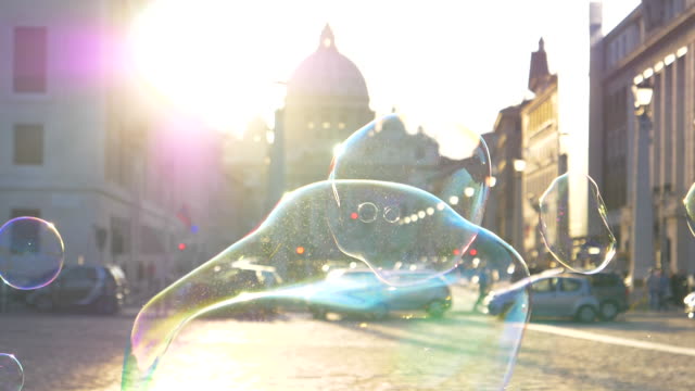 LENS-FLARE:-Colorful-soap-bubbles-fly-around-the-sunlit-square-in-Vatican-City.