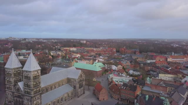 Aerial-view-of-Lund-Cathedral-building-in-Skåne,-Southern-Sweden.-4K-drone-shot-flying-over-historical-church-landmark-in-Lund-city