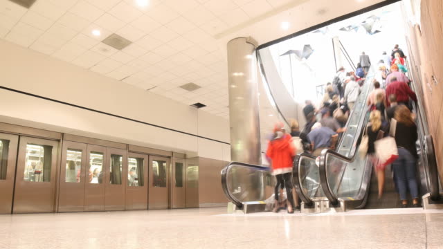 Looping-people-at-train-stop-and-escalator---Time-lapse-4k