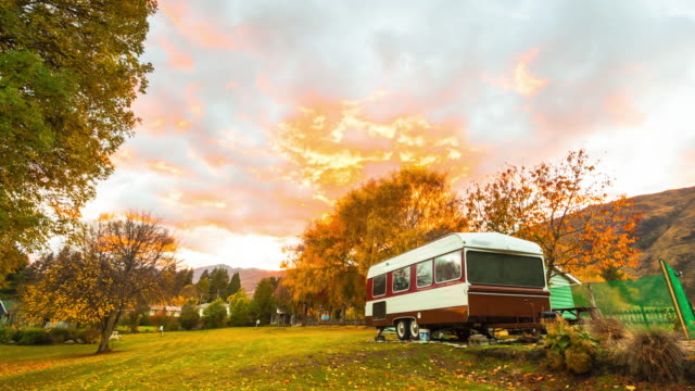 4K:-Autumn-sunrise-at-a-family-park,-with-camper-vans-at-New-Zealand