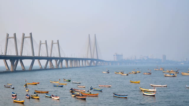 Colorful-fishing-boats-are-parked-under-the-modern-cable-satyed-bridge