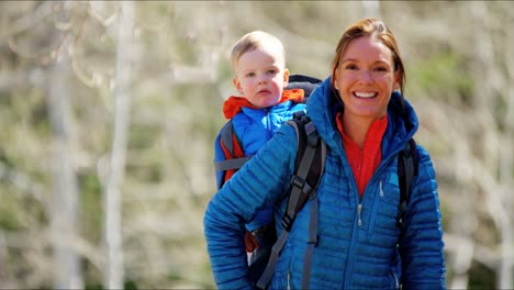 Portrait-Caucasian-mother-outdoors-young-son-baby-carrier