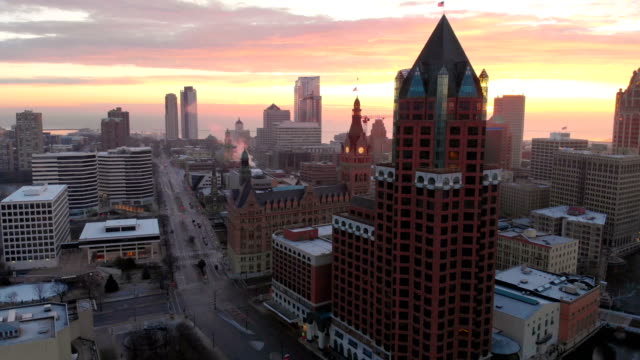 Aerial-view-of-skyscrapers-in-american-city-at-dawn.-Downtown-Milwaukee,-Wisconsin,-United-States.-Drone-shots,-sunrise,-sunlight,-from-above.