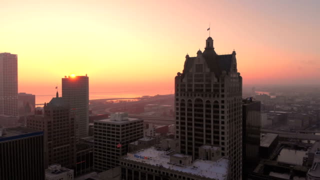 Aerial-view-of-skyscrapers-in-american-city-at-dawn.-Downtown-Milwaukee,-Wisconsin,-United-States.-Drone-shots,-sunrise,-sunlight,-from-above.