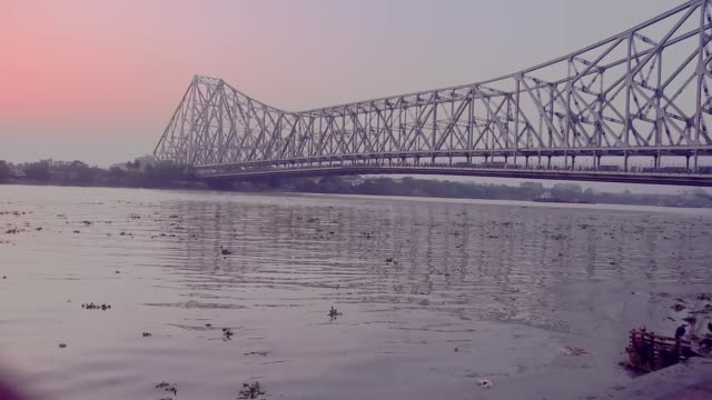 Wasserwelle-in-verschmutztem-Fluss-Ganga-in-der-Nähe-von-Howrah-Brücke,-Kolkata-(Indien)-bei-Sonnenuntergang