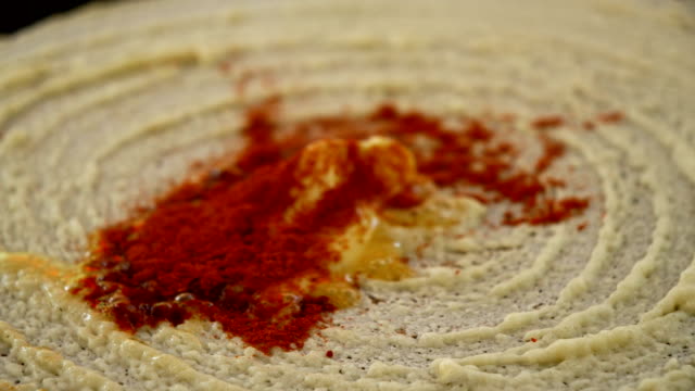 Closeup-of-frying-dosa-with-ghee,-chilli-and-coriander