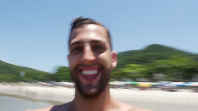 Man-on-vacation-laughing-at-the-beach