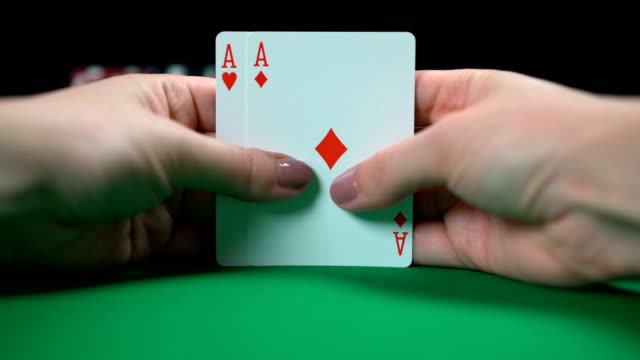 Poker-player-showing-a-pair-of-aces,-good-hand,-high-chances-of-winning,-luck