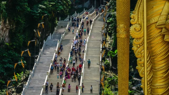 Tourist-flow-on-steps-of-stairs-near-Lord-Murugan-Hindu-Deity-Statue-at-Batu-Caves-in-Malaysia-Timelapse-4K