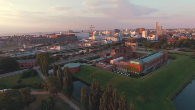 Aerial-view-of-Malmo-city-at-sunset.-Drone-shot-flying-over-"Malmohus"-in-Sweden