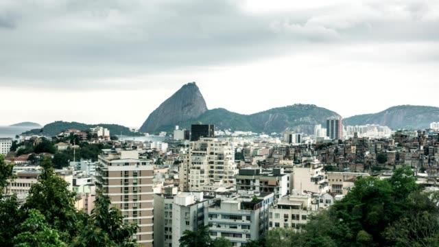 Sugarloaf-from-Santa-Teresa,-in-Rio-de-Janeiro,-with-cityscape-view-in-storm-sky-timelapse