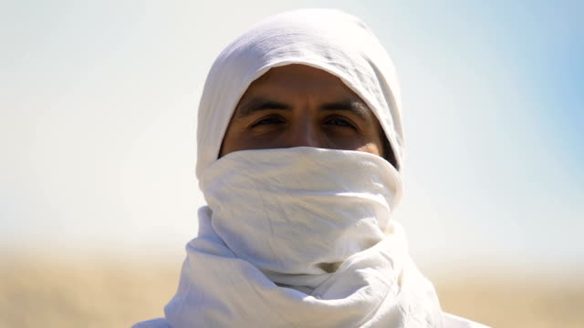 Portrait-of-man-muslim-hiding-face-under-white-clothing,-islamic-traditions