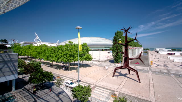 Escultura-moderna-y-el-centro-de-compras-en-Parque-das-Nacoes,-Parque-de-las-Naciones,-Lisboa,-Portugal-timelapse