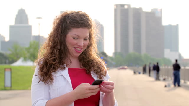 Slow-motion-brunette-using-a-smart-phone-in-Detroit