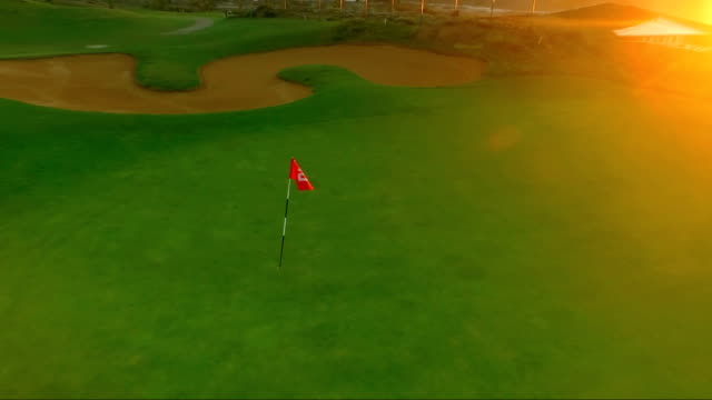 Fly-around-the-golf-pin-on-the-sunset-background
