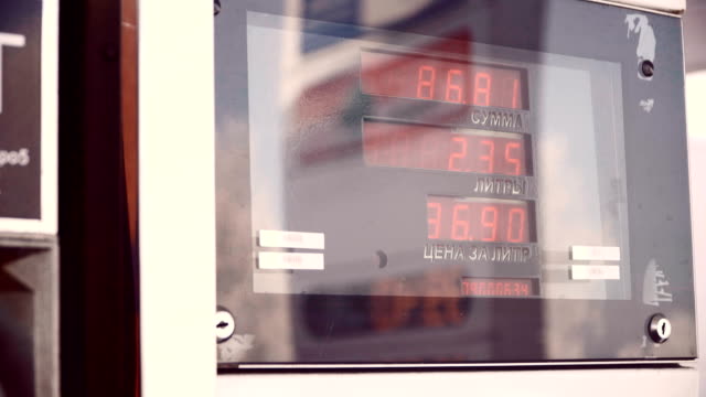 Display-for-petrol.-The-driver-pumping-gasoline-at-the-gas-station.