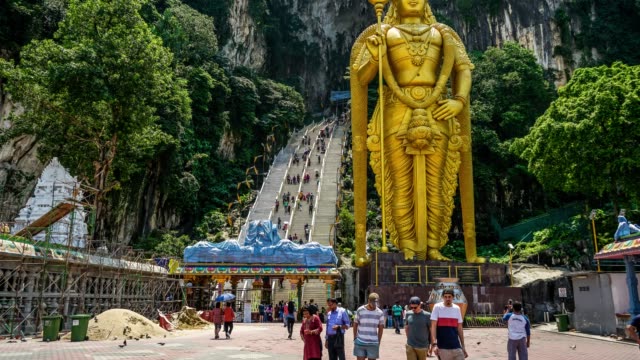 Señor-Murugan-estatua-de-deidad-hindú-en-el-flujo-turístico-y-cuevas-de-Batu-en-lapso-de-tiempo-de-Malasia-4K