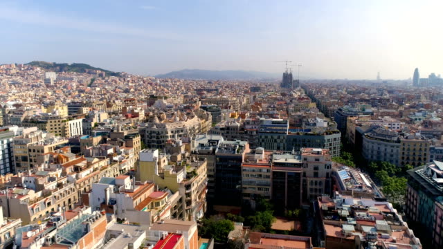 Aerial-above-Barcelona-Eixample-district-rooftops,-morning-light,-Spain