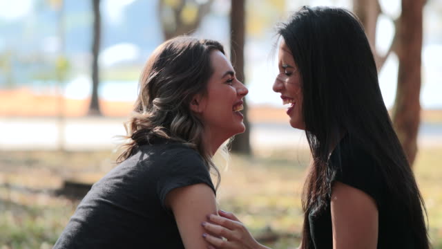 Lesbian-couple-kissing-each.-LGBT-Girlfriend-kisses-female-mate-at-the-park
